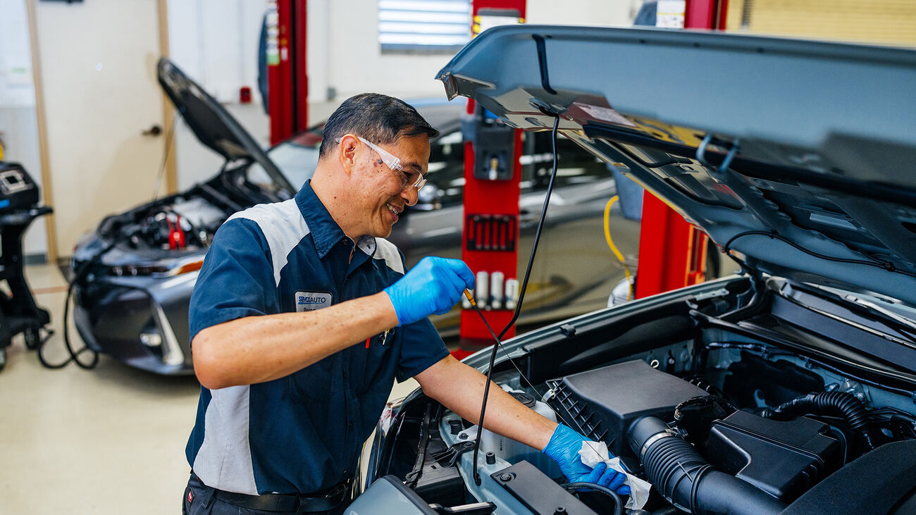 Toyota-certified technician performing an oil change 