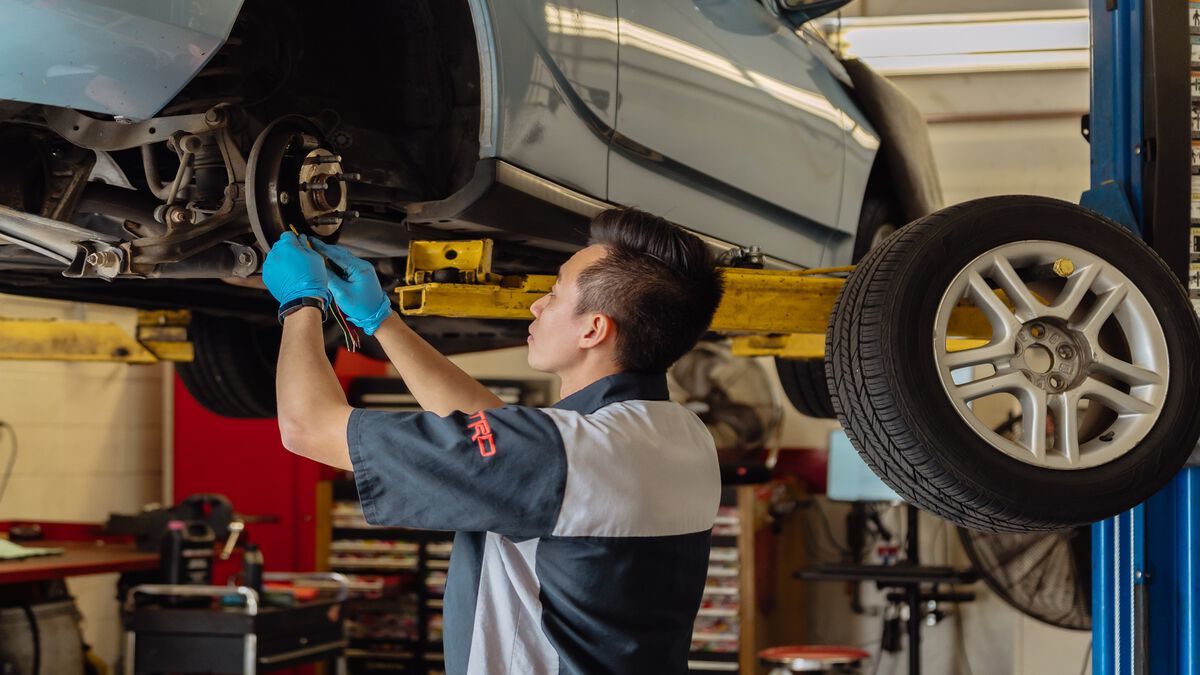 Toyota Service Technician inspecting disc rotors