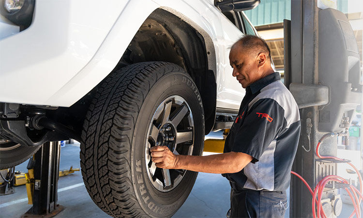 Servco Toyota Service Technician adjusting tire